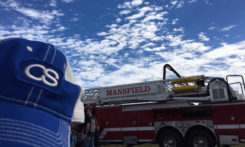 C&S insurance hat in front of fire truck at annual Touch a Truck