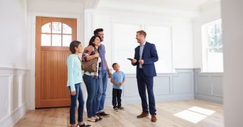 agent advising family about insurance quote before buying house
