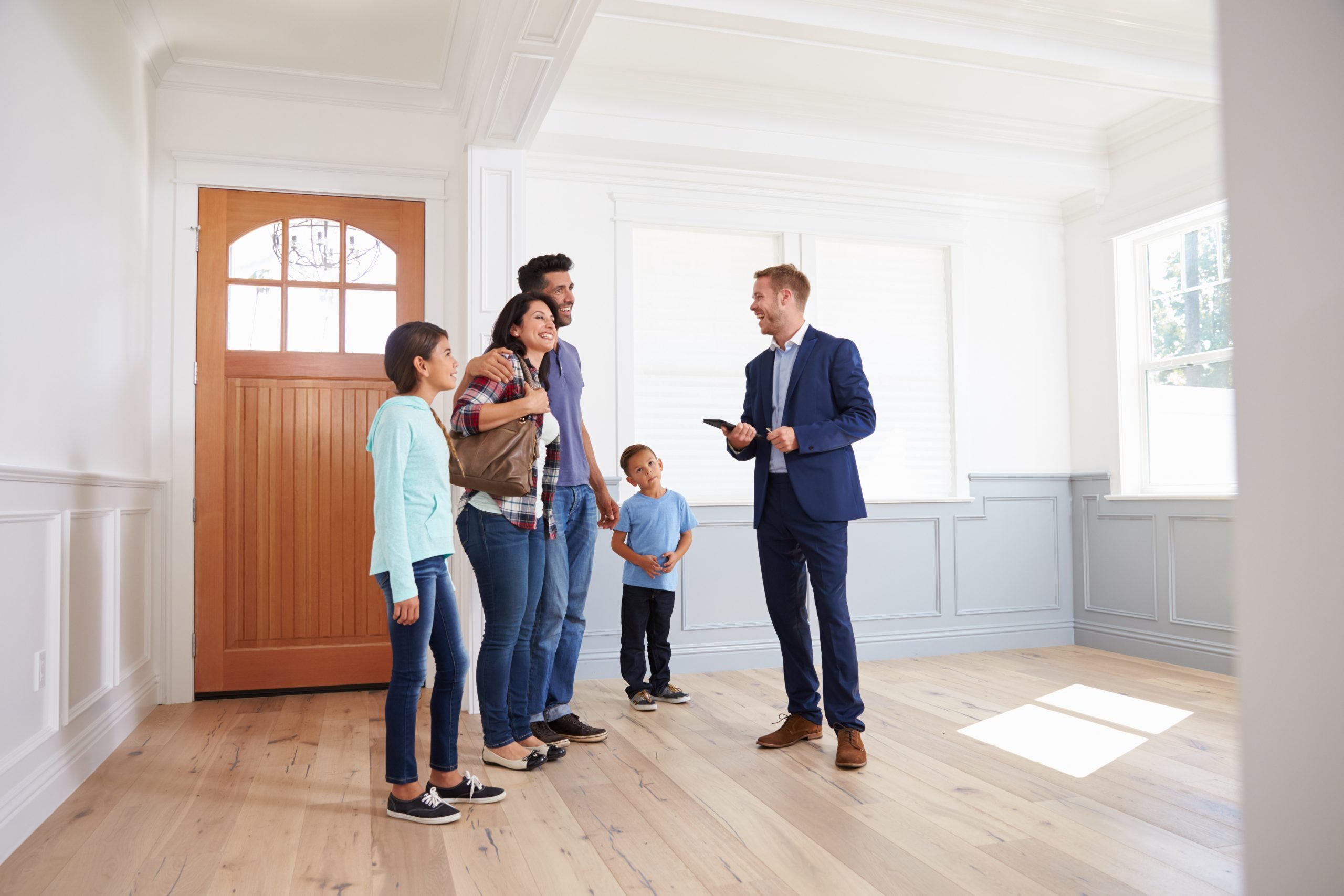 agent advising family about insurance quote before buying house