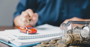 Concept of car insurance business, saving buy - sale with tax and loan for new car. Car toy vehicle with stack coin money on background. Planning to manage transportation finance costs. loan for car
