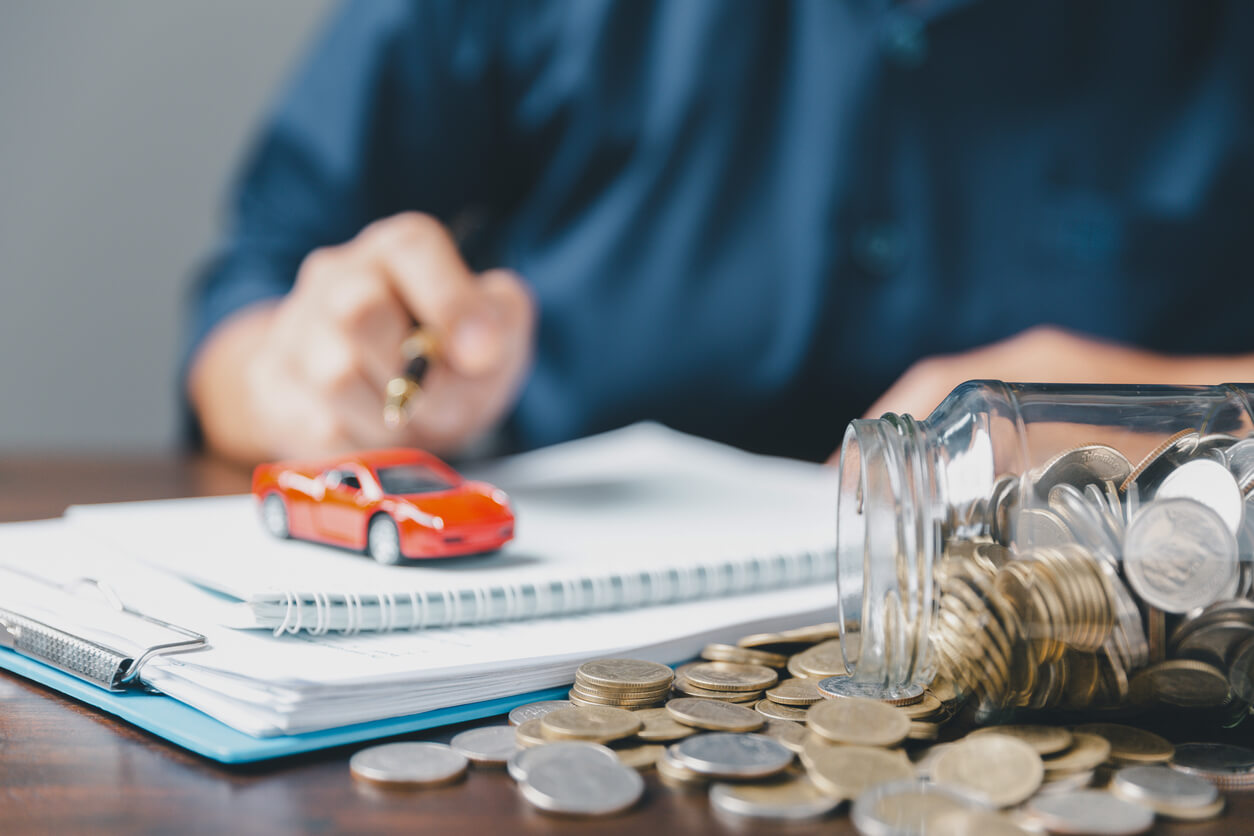 Concept of car insurance business, saving buy - sale with tax and loan for new car. Car toy vehicle with stack coin money on background. Planning to manage transportation finance costs. loan for car
